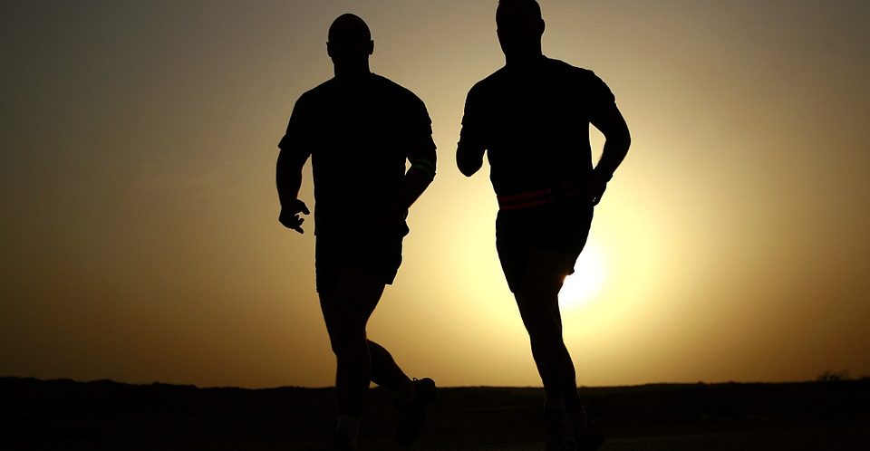 Silhouette von zwei Männern, die nebeneinander joggen